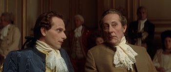 Movie still from “Ridicule” (1996), directed by Patrice Leconte – Two men in period clothing looking at each other; Close Up shot, Over the shoulder angle