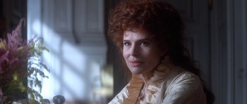 Movie still from “Ridicule” (1996), directed by Patrice Leconte – A person with curly red hair; Close Up shot, Over the shoulder angle