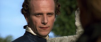 Movie still from “Ridicule” (1996), directed by Patrice Leconte – A person wearing a jacket; Close Up shot, Low angle