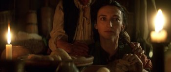 Movie still from “Ridicule” (1996), directed by Patrice Leconte – A woman sitting in front of a bowl of food; Close Up shot, Over the shoulder angle