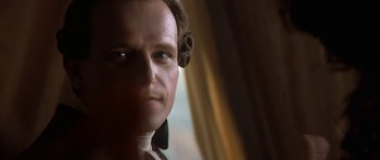 Movie still from “Ridicule” (1996), directed by Patrice Leconte – The face of a wax figure of a man; Close Up shot, Over the shoulder angle