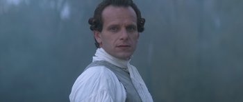 Movie still from “Ridicule” (1996), directed by Patrice Leconte – A person wearing a white shirt; Close Up shot, Low angle