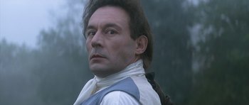 Movie still from “Ridicule” (1996), directed by Patrice Leconte – A person wearing a white shirt; Close Up shot, Low angle