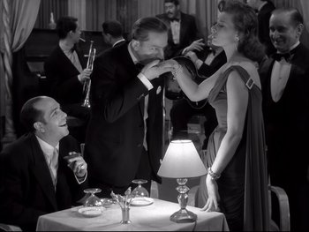 Movie still from “Rififi” (1955), directed by Jules Dassin – A man and a woman at a dinner table; Medium shot, Low angle