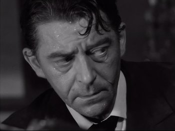Movie still from “Rififi” (1955), directed by Jules Dassin – Black and white photograph of a man crying; Close Up shot, High angle