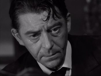 Movie still from “Rififi” (1955), directed by Jules Dassin – Black and white photograph of a man crying; Close Up shot, High angle