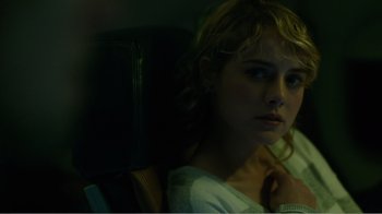 Movie still from “Rings” (2017), directed by F. Javier Gutiérrez – A woman sitting in a chair looking at the camera; Close Up shot, Over the shoulder angle