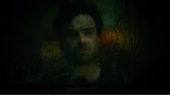 Movie still from “Rings” (2017), directed by F. Javier Gutiérrez – A man is looking out of a window at night; Close Up shot, High angle