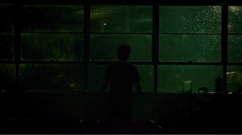 Movie still from “Rings” (2017), directed by F. Javier Gutiérrez – A man standing in front of a window at night; Extreme Wide shot, High angle