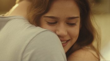 Movie still from “Rings” (2017), directed by F. Javier Gutiérrez – A person hugging another person; Close Up shot, Over the shoulder angle