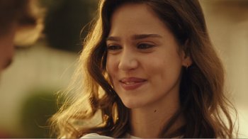 Movie still from “Rings” (2017), directed by F. Javier Gutiérrez – A woman smiling for the camera; Close Up shot, Over the shoulder angle