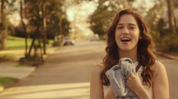 Movie still from “Rings” (2017), directed by F. Javier Gutiérrez – A woman holding a towel and laughing; Medium shot, Over the shoulder angle