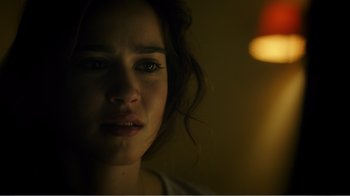 Movie still from “Rings” (2017), directed by F. Javier Gutiérrez – A young woman stares into the camera with her eyes wide open; Close Up shot, Over the shoulder angle