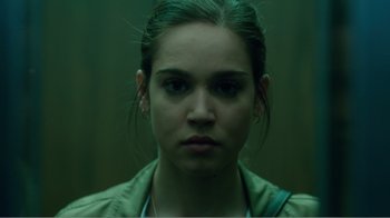 Movie still from “Rings” (2017), directed by F. Javier Gutiérrez – A young woman is looking into the camera; Close Up shot, Low angle