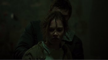 Movie still from “Rings” (2017), directed by F. Javier Gutiérrez – A man and a woman in a dark room; Close Up shot, Over the shoulder angle