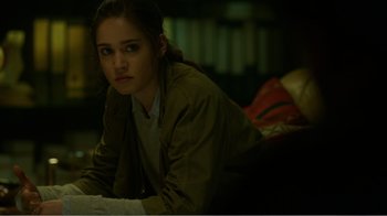 Movie still from “Rings” (2017), directed by F. Javier Gutiérrez – A woman is laying down on the floor in the dark; Close Up shot, Over the shoulder angle