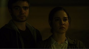 Movie still from “Rings” (2017), directed by F. Javier Gutiérrez – A man and a woman standing next to each other in the dark; Close Up shot, Low angle