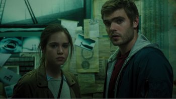 Movie still from “Rings” (2017), directed by F. Javier Gutiérrez – A man and a woman standing next to each other; Close Up shot, Low angle