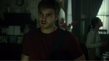 Movie still from “Rings” (2017), directed by F. Javier Gutiérrez – A man with a bag in a dark room; Close Up shot, Over the shoulder angle