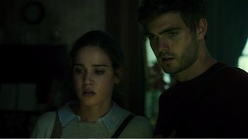 Movie still from “Rings” (2017), directed by F. Javier Gutiérrez – A man and a woman standing next to each other in the dark; Close Up shot, Low angle