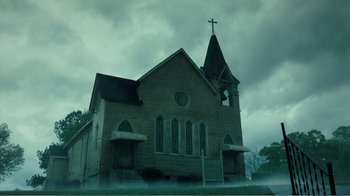 Movie still from “Rings” (2017), directed by F. Javier Gutiérrez – An old church with a steeple and a cross on the steeple; Extreme Wide shot, Low angle