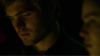 Movie still from “Rings” (2017), directed by F. Javier Gutiérrez – A man's face in the dark; Close Up shot, Over the shoulder angle