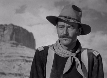 Movie still from “Rio Grande” (1950), directed by John Ford – A man with a hat and a neck tie; Close Up shot, Low angle