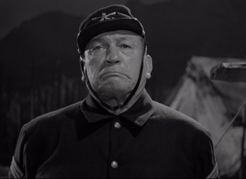 Movie still from “Rio Grande” (1950), directed by John Ford – An old man in a uniform is looking at the camera; Close Up shot, Low angle