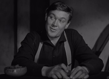 Movie still from “Rio Grande” (1950), directed by John Ford – A black and white photo of a man smiling; Close Up shot, Low angle