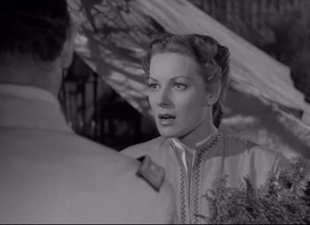 Movie still from “Rio Grande” (1950), directed by John Ford – A black - and - white photo of a woman looking at a man; Close Up shot, Over the shoulder angle