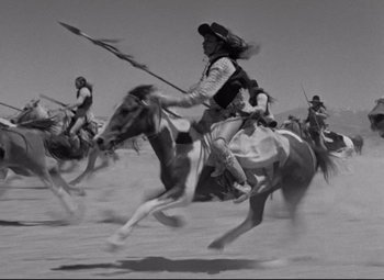 Movie still from “Rio Grande” (1950), directed by John Ford – A black and white photo of a group of people riding horses; Wide shot, High angle