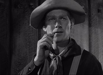 Movie still from “Rio Grande” (1950), directed by John Ford – A black and white photo of a man wearing a cowboy hat; Close Up shot, Low angle