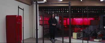 Movie still from “Ritual” (2000), directed by Hideaki Anno – A man standing on top of a skate board; Wide shot, Low angle