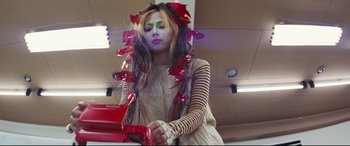 Movie still from “Ritual” (2000), directed by Hideaki Anno – A woman with long hair and red flowers in her hair; Medium shot, Low angle