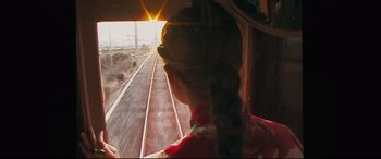 Movie still from “Ritual” (2000), directed by Hideaki Anno – A woman is looking out the window of a train; Close Up shot, High angle