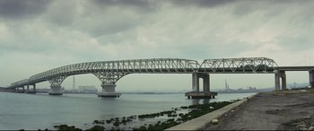Movie still from “Ritual” (2000), directed by Hideaki Anno – A bridge that is over a body of water; Extreme Wide shot, Low angle