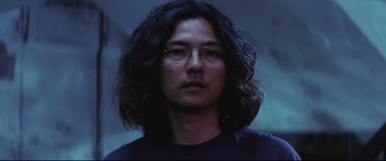 Movie still from “Ritual” (2000), directed by Hideaki Anno – A person with long hair; Close Up shot, Low angle