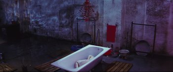 Movie still from “Ritual” (2000), directed by Hideaki Anno – A bath tub in the middle of a bathroom; Wide shot, Overhead angle