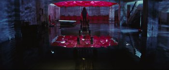 Movie still from “Ritual” (2000), directed by Hideaki Anno – A person standing in a room with a red umbrella; Extreme Wide shot, Overhead angle