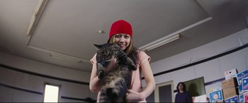 Movie still from “Ritual” (2000), directed by Hideaki Anno – A woman holding a cat in her arms; Medium shot, Low angle