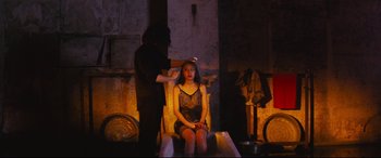 Movie still from “Ritual” (2000), directed by Hideaki Anno – A woman sitting in a chair getting her hair done; Medium shot, Over the shoulder angle