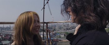 Movie still from “Ritual” (2000), directed by Hideaki Anno – Two people are looking at each other while standing on a hot air balloon; Close Up shot, Low angle