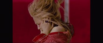 Movie still from “Ritual” (2000), directed by Hideaki Anno – A woman with her hair blowing in the wind talking on a cell phone; Close Up shot, Overhead angle