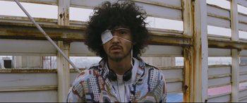 Movie still from “Ritual” (2000), directed by Hideaki Anno – A man with a bandage on his eye wearing headphones; Close Up shot, Low angle