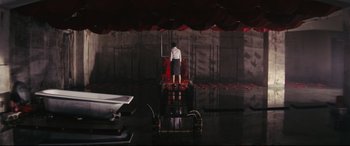 Movie still from “Ritual” (2000), directed by Hideaki Anno – A man standing on a platform in front of a stage; Extreme Wide shot, High angle