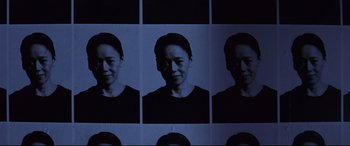 Movie still from “Ritual” (2000), directed by Hideaki Anno – A series of photographs of a woman's face; Close Up shot, Low angle