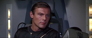 Movie still from “Robinson Crusoe on Mars” (1964), directed by Byron Haskin – A person wearing a suit and tie; Close Up shot, High angle