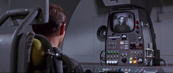 Movie still from “Robinson Crusoe on Mars” (1964), directed by Byron Haskin – A man is sitting in front of a television; Medium shot, Over the shoulder angle