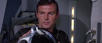 Movie still from “Robinson Crusoe on Mars” (1964), directed by Byron Haskin – A person holding a steering wheel; Close Up shot, Low angle