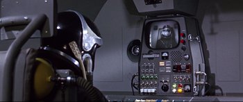 Movie still from “Robinson Crusoe on Mars” (1964), directed by Byron Haskin – A person in a space suit is in a control room; Close Up shot, Over the shoulder angle